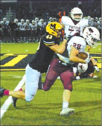 Tony McSwain • Courtesy Photo Senior John Venable #43, bringing down one of the Tuttle Tigers.