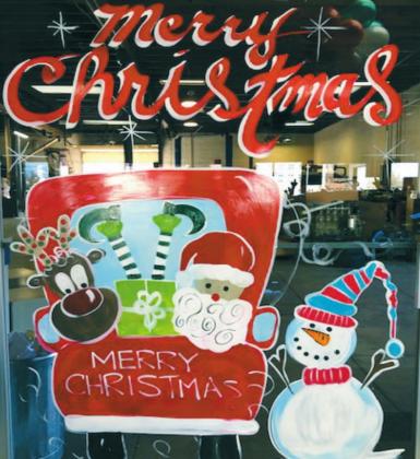 Julie Riggs Sisson paints business fronts. The photo above is one of her many stops. This year, in lieu of payment, Sisson requested her customers to donate to the local nursing homes. Courtesy photo