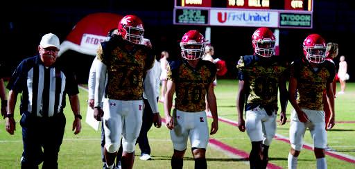 Stan Self walking onto the field with Kingston seniors Haydyn Cervantes, Klete Finley, Devon Tipton and Chandler Hansley. Mindi Weeks