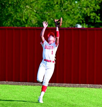 The Lady Redskins won 16-9 over Latta during their Monday night home game. Pictured left: Gracie Bridgman winds up for a winning pitch. Pictured right: Emma Bridgeman runs for a catch. Courtesy photos