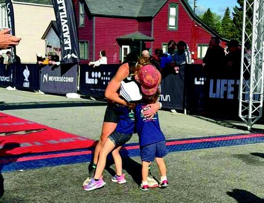Courtesy photo A photograph shared by Donna Bearden shows Hadeed embracing two children beneath the Leadville Trail 100 finish banner.