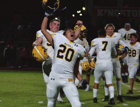 Jose Menchaca celebrates the win over Kingston while his teammates celebrate in the background. Summer Bryant • The Madill Record
