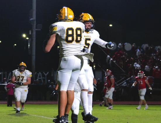 River Shaw and Caden McHatton celebrate a touchdown that cemented the Madill win during the Marshall County Superbowl on October 29, 2021. Summer Bruant • The Madill Record