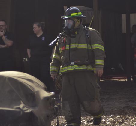 A firefighter exits the house after putting out the blaze. Photo courtesy ot Ross Pinson