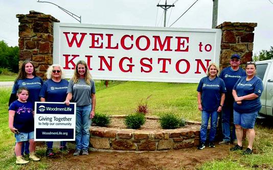 Sherri Elmore with Woodmen Life Insurance funded the makeover project of the Welcome to Kingston sign. Cody Cox powerwashed the sign prior to painting and some volunteers planted the new plants. Courtesy photo