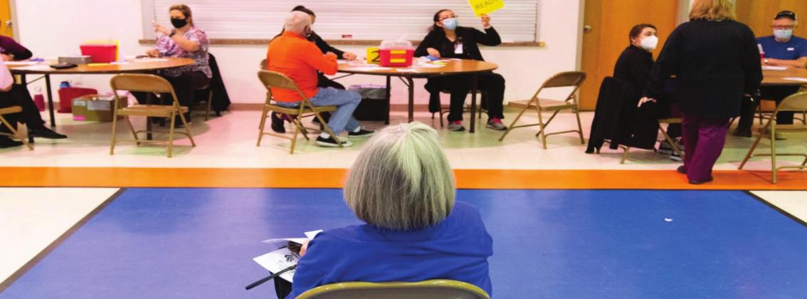 A woman sits in the observation area after receiving the COVID-19 vaccine at a church in Lawton where the Comanche County Health Department administered 650 vaccines to individuals 65 and older last month. Whitney Bryen • Oklahoma Watch