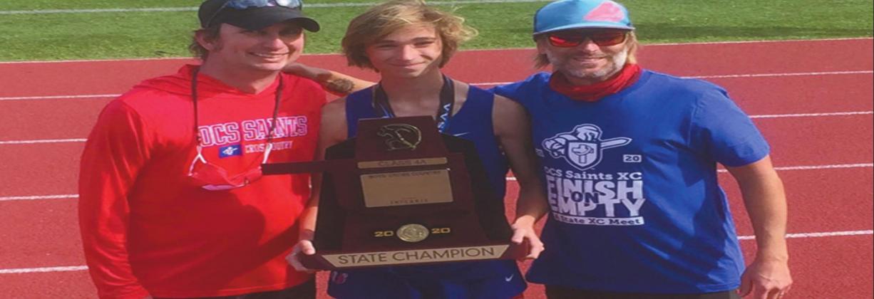 Coaches Rodney Nichols (left), and Brent Stovall (right) pose with Ethan (center) holding the trophy after placing second place at the meet. Courtesy photo
