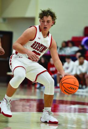 Crockett Uber Parks Ratzlaff dribbles down the court during a basketball game.
