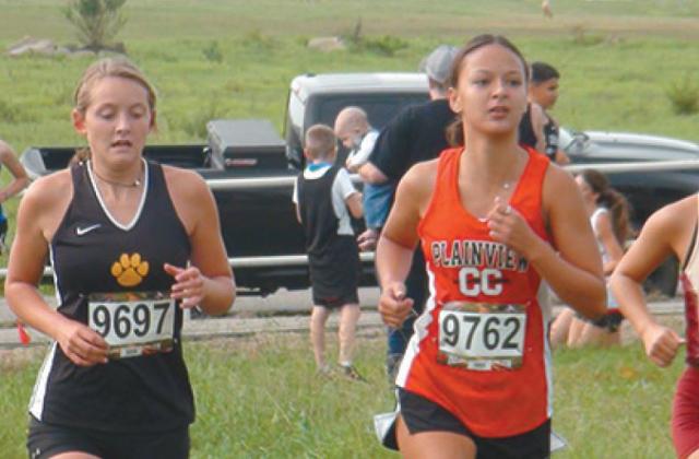 Korlee Cunningham and a runner from Plainview keep pace with each other. Korlee placed fourth place in the Lake Country Conference on September 12. Courtesty photo