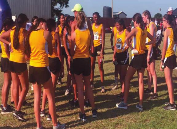 The Madill Girls Cross Country get some last minute advice before competing. Photo courtesy of Savannah Martin
