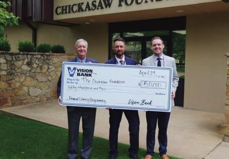 From left, Steve Bagwell, president and CEO of Vision Bank; Justin Williams, president of the Chickasaw Foundation; and Blake Long, communication and project manager for the Chickasaw Foundation, hold a ceremonial check from Vision Bank to the Chickasaw Foundation supporting financial literacy initiatives. Courtesy photo