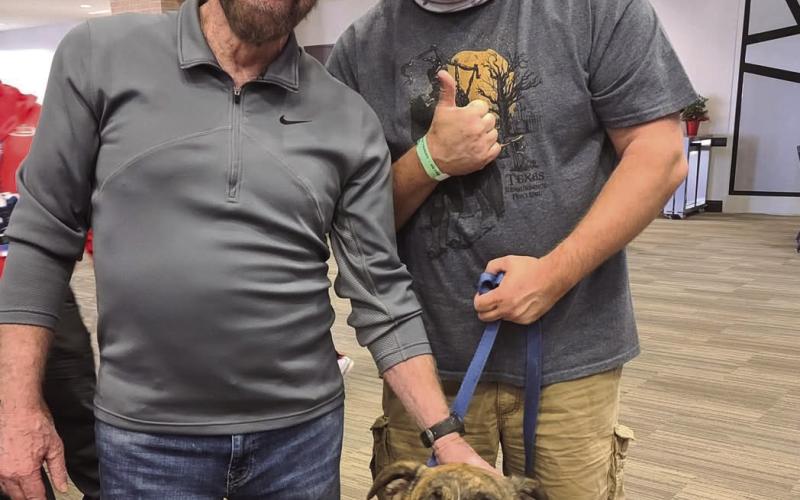 Chuck Norris meets a fan at an autograph signing event. Courtesy photo