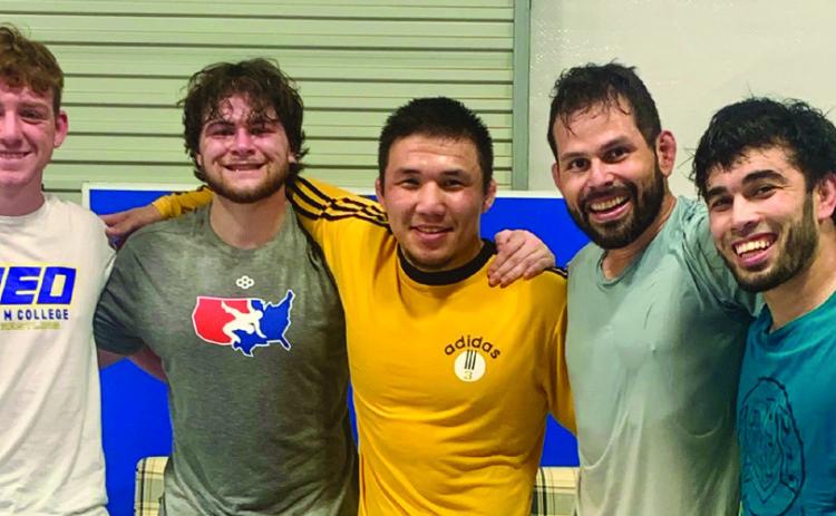 Nurkozha Kaipanov, center, standing with Marshall Mansfield, Chase Saba, Peter Hammer and Mirzo Khayitov (left to right). Courtesy photo